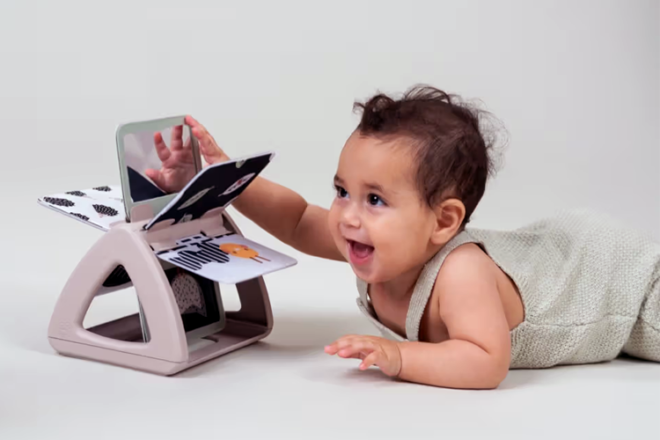 baby playing with spinning baby book