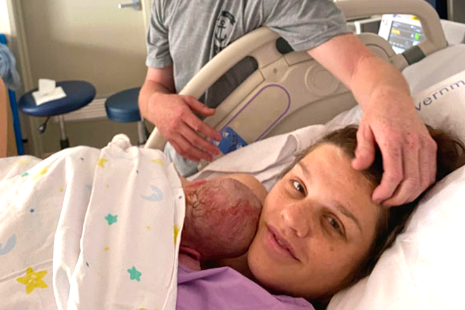 Mother holding her newborn in a hospital bed