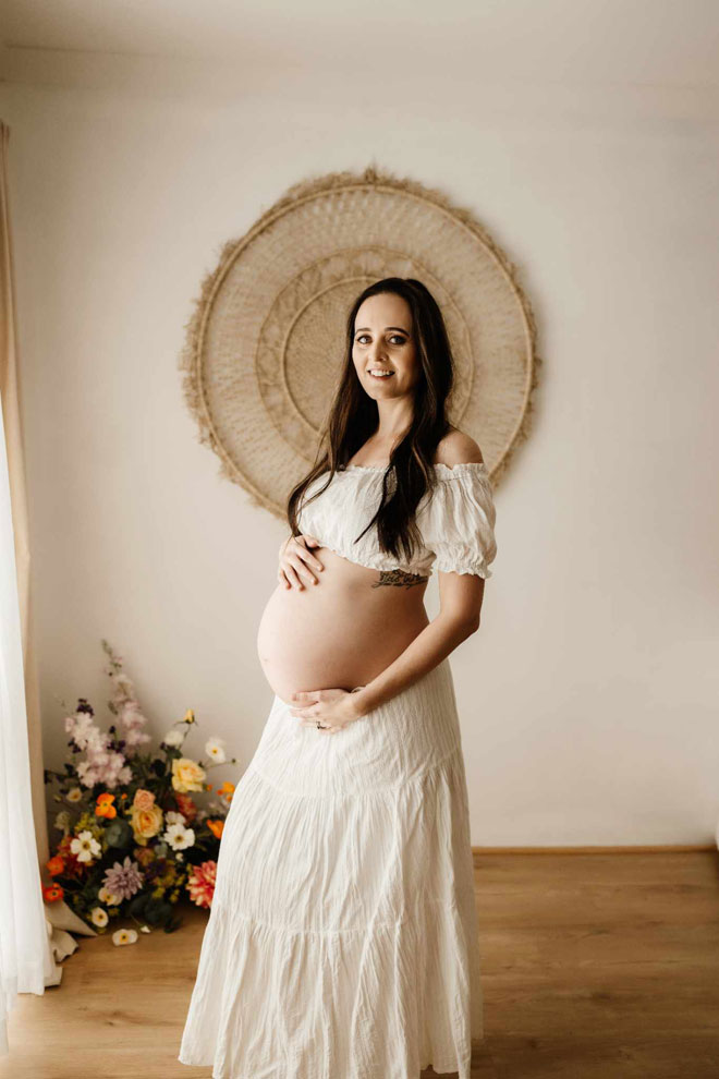 Ally posing pregnant for maternity shoot