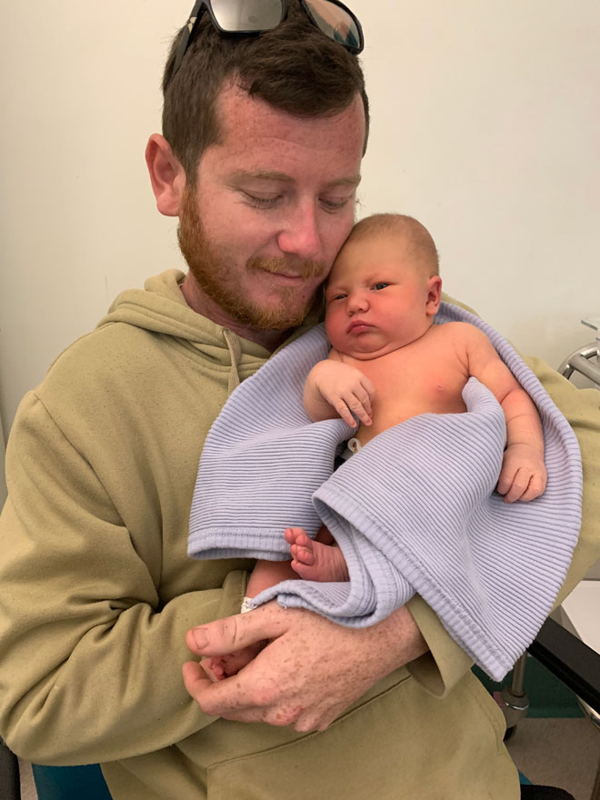 Andrew holding newborn Daisy