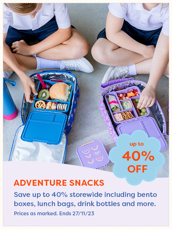 Two kids sitting lunch out of Adventure Snacks bento boxes
