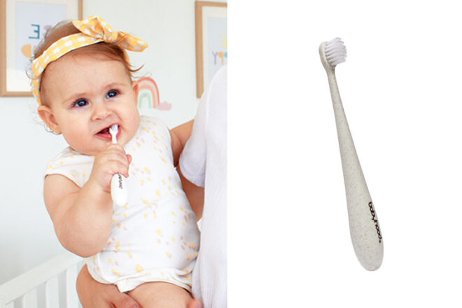 A baby holding the Babyhood infant toothbrush in her mouth
