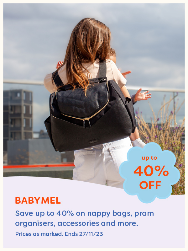 Mother wearing Babymel black baby nappy bag