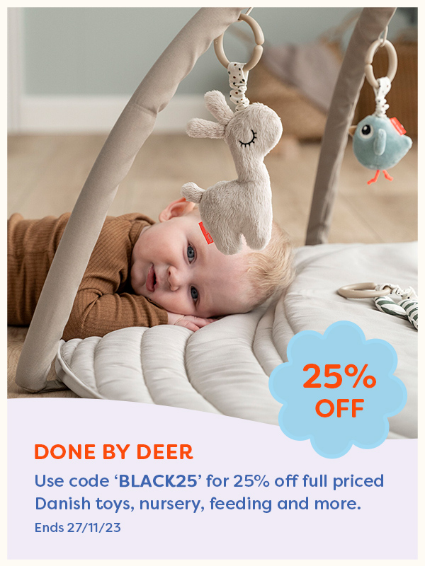 Baby lying on a Done by Deer Activity Gym