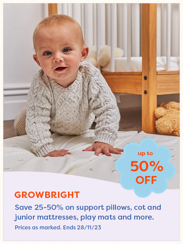 A baby crawling on a growbright mattress