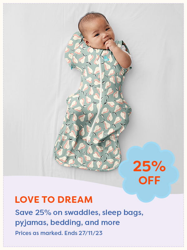 A baby wearing a Love to Dream sleep swaddle