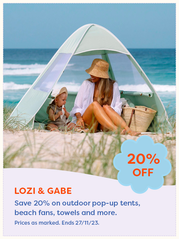A woman and child sitting in a Lozi & Gabe pop up tent on a beach