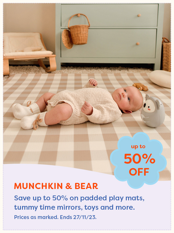 Baby lying on a beige gingham padded play mat from Munchkin & Bear