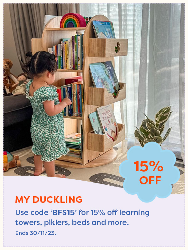 A child playing next to a My Duckling book case