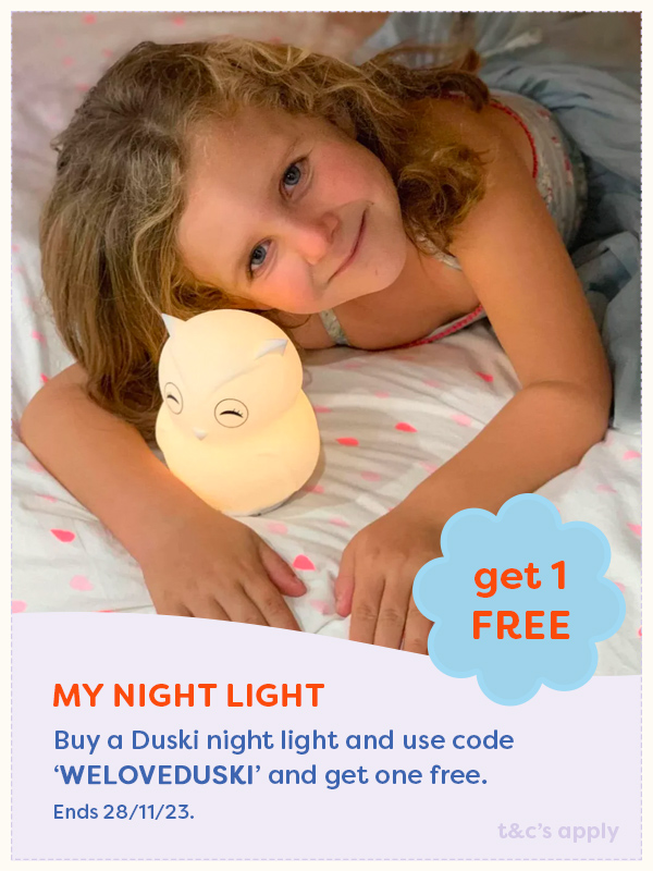 A child laying next to a My Night Light night light