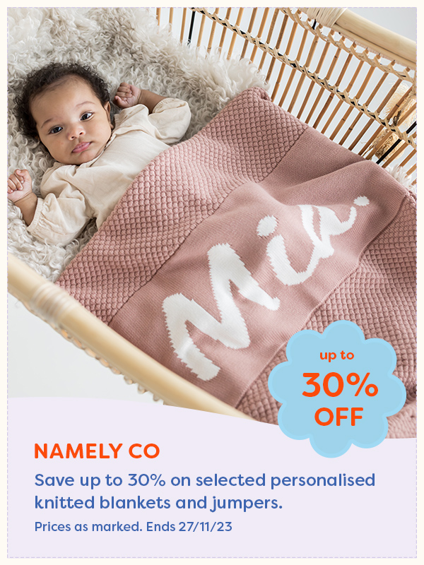 A baby laying under a Namely Co personalised baby blanket