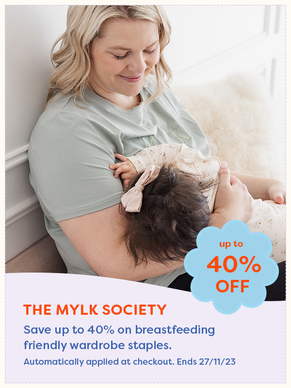 A mother nursing her baby wearing The Mylk Society nursing tshirt