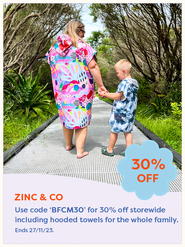A woman and young boy wearing hooded beach towels from Zinc & Co