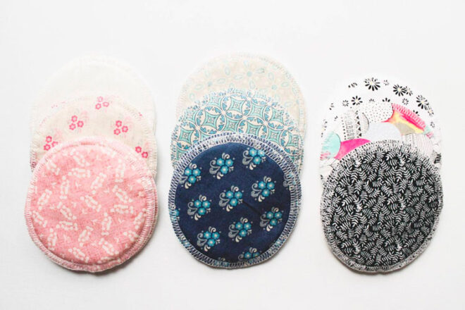 Three piles of Zoe and Sage washable nursing pads in different designs
