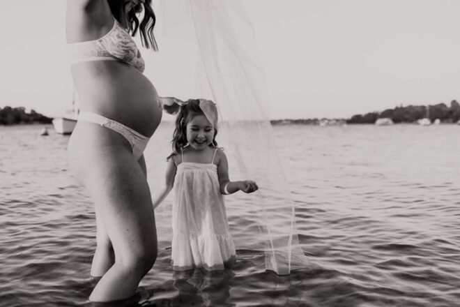 Melissa and daughter Zoe in water during maternity photoshoot
