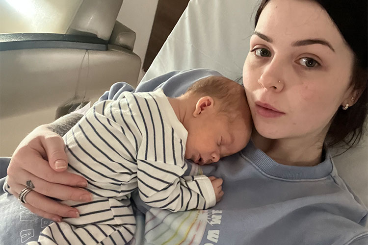 Brooke in hospital cuddling her baby