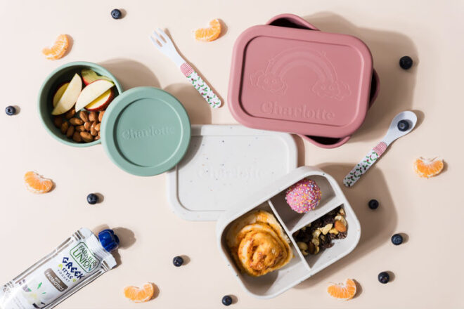 Mapley bento boxes in different colours surrounded by food and other cutlery and containers
