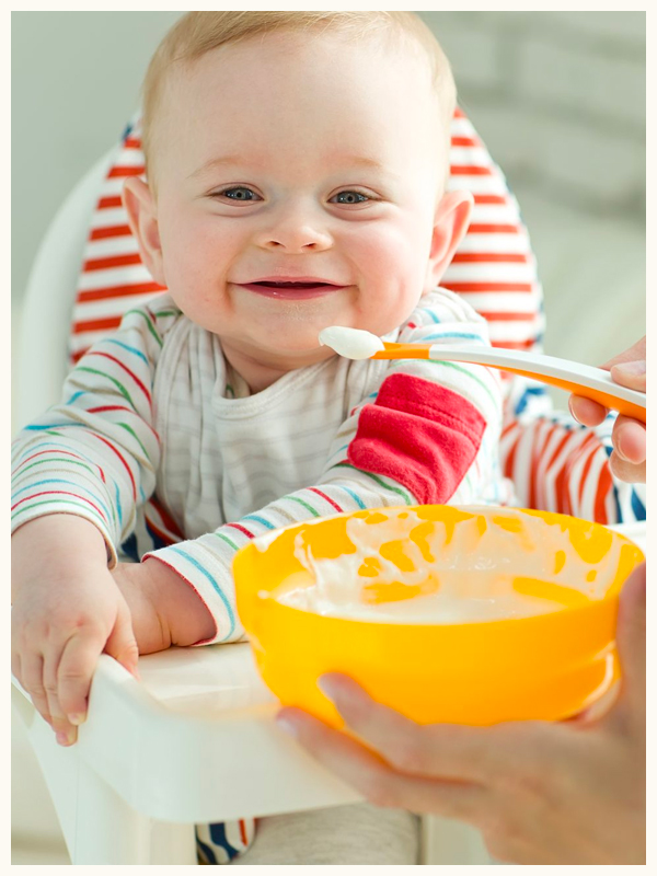 Illustration of mother feeding baby with a spoon