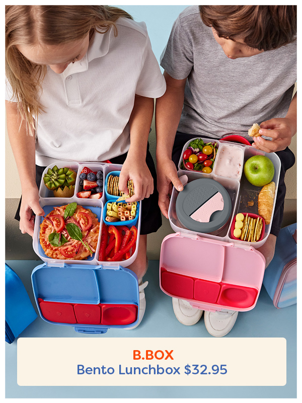 Two children sitting each with a b.box bento box in their laps