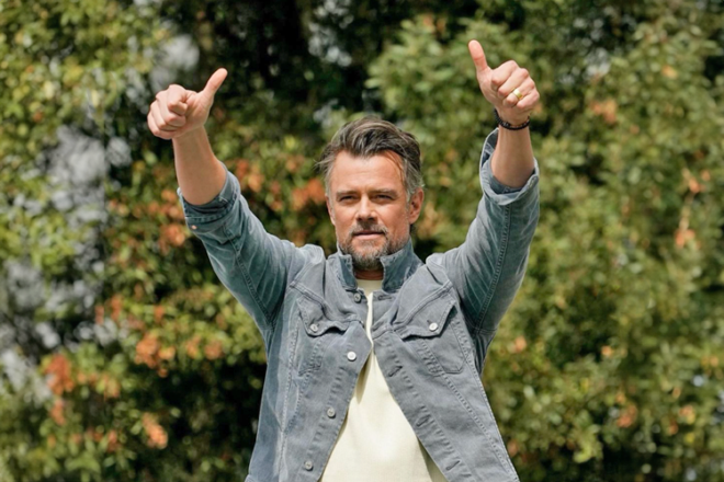 Actor Josh Duhamel with his hands up giving the two thumbs up
