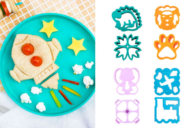 Lunch Punch sandwich cutters in a rocket shape next to four different themed cutters in dinosaur, lion, fairies and transit