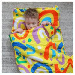 A child laying in the Morgy + Wills Daycare Nap Mat