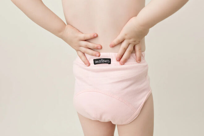 toddler wearing day time pink training pants for toileting