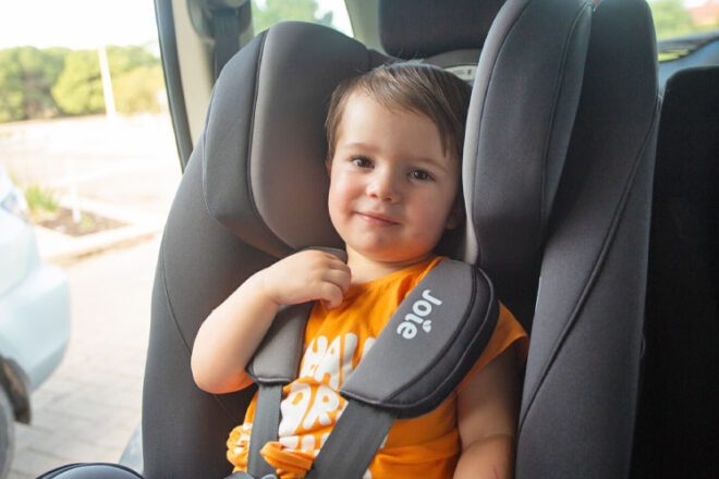 Little boy sitting in the Joie Nuna Baby Car seat