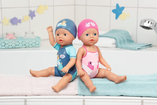 boy and girl bath dolls sitting on the edge of the bath