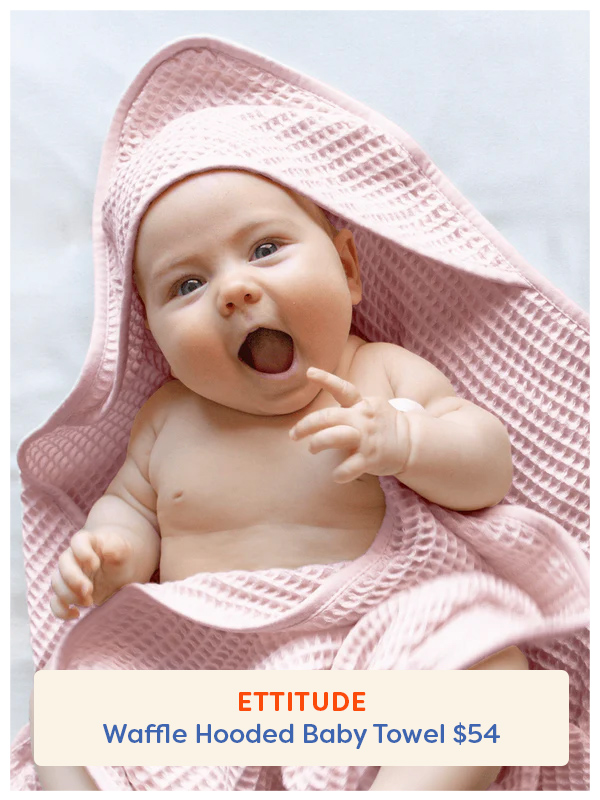 Baby wearing the Ettitude Waffle Hooded Bath Towel
