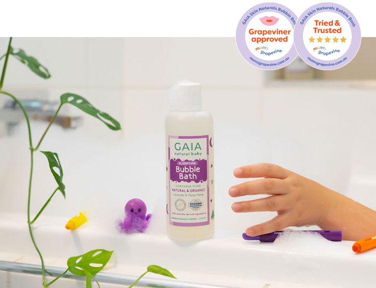GAIA Skin Natural Bubble Bath sitting on the side of a tub