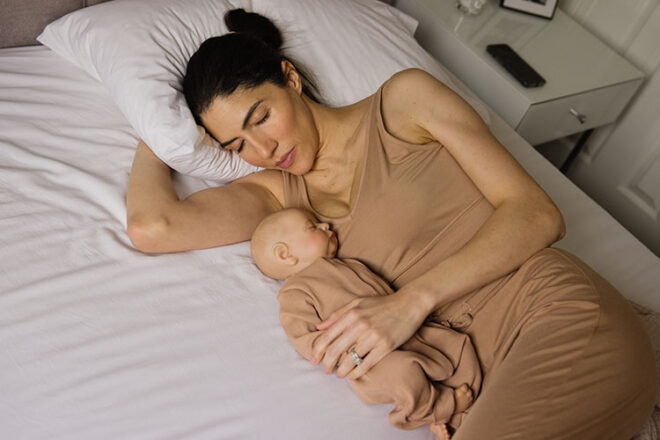 A mother co-sleeping with her baby