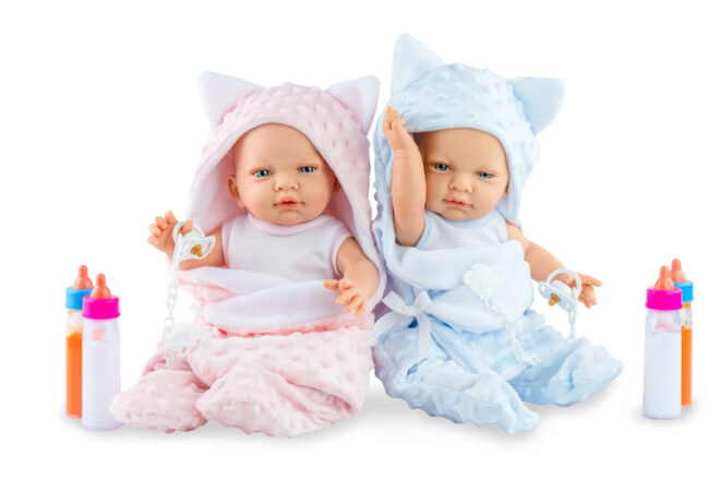 two dolls sitting in bath robes 