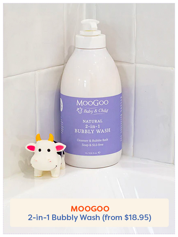 Bottle of MooGoo 2 in 1 Bubbly Wash in the bath with a toy rubber cow
