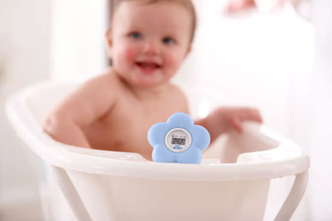 Baby sitting in a bath with the Philip Avent Digital Bath Thermometer