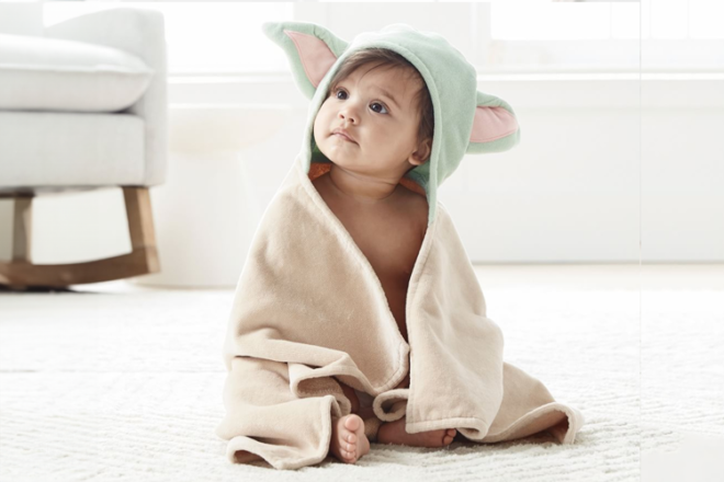 Young child looking at the camera wearing a Yoda Hooded Towel