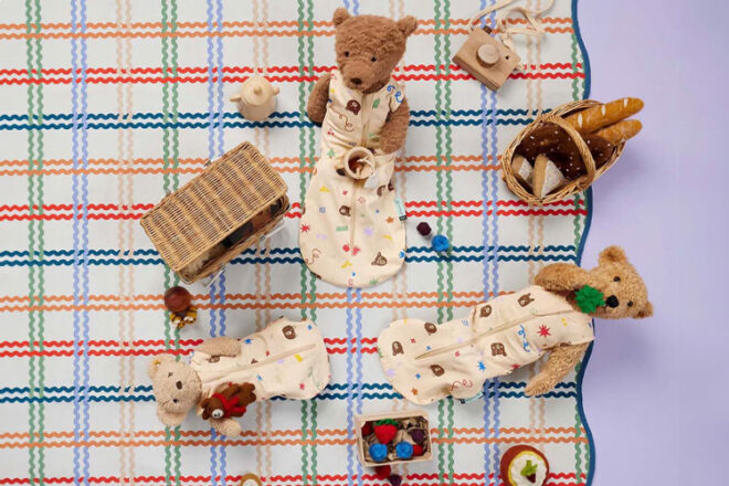 Three teddy bears wearing ergoPouch's doll sleeping bags from the new Teddy Bear collection