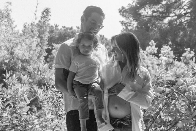 Actress Ashley Tisdale and her family in a black and white photo announcing her pregnancy