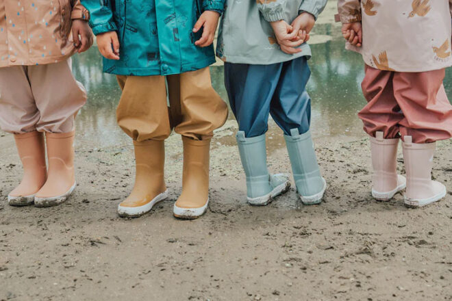 Four children standing wearing Cry Wolf Kids Gumboots in various colours