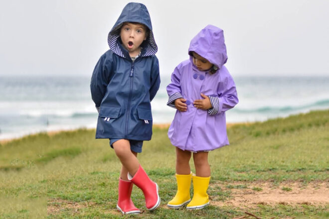 boy and girl wearing a navy and lavender French Soda kids raincoat
