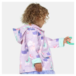 A little girl wearing a Penny Scallan Kids raincoat in the design Loopy Llama