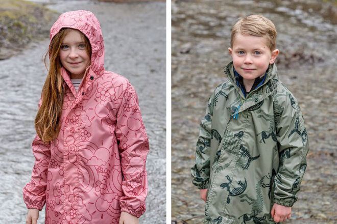 Two young kids wearing Rainbird Clothing STOWaway Kids Rain Jackets in Dream and Dino