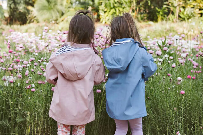 Two little girls wearing Rainkoat Stripy Sailor Jackets in Blush Pink and Lavendar