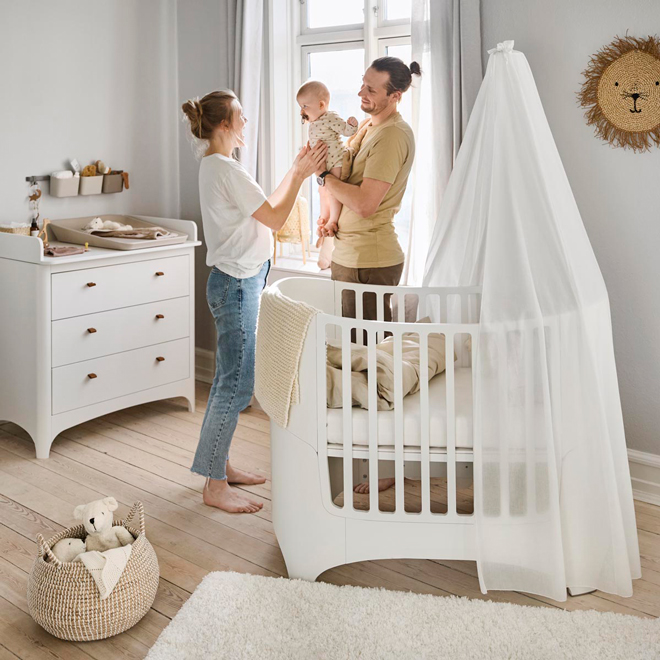 Mother, father and baby in a Leander nursery