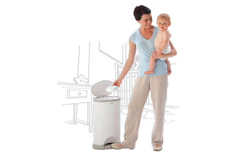 mother holding baby while putting a nappy into the Korbell Nappy Bin Disposal System