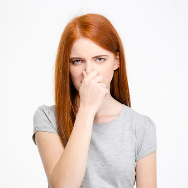 Girl holding her nose closed for bad smell