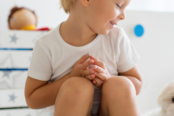Young boy sitting on a potty