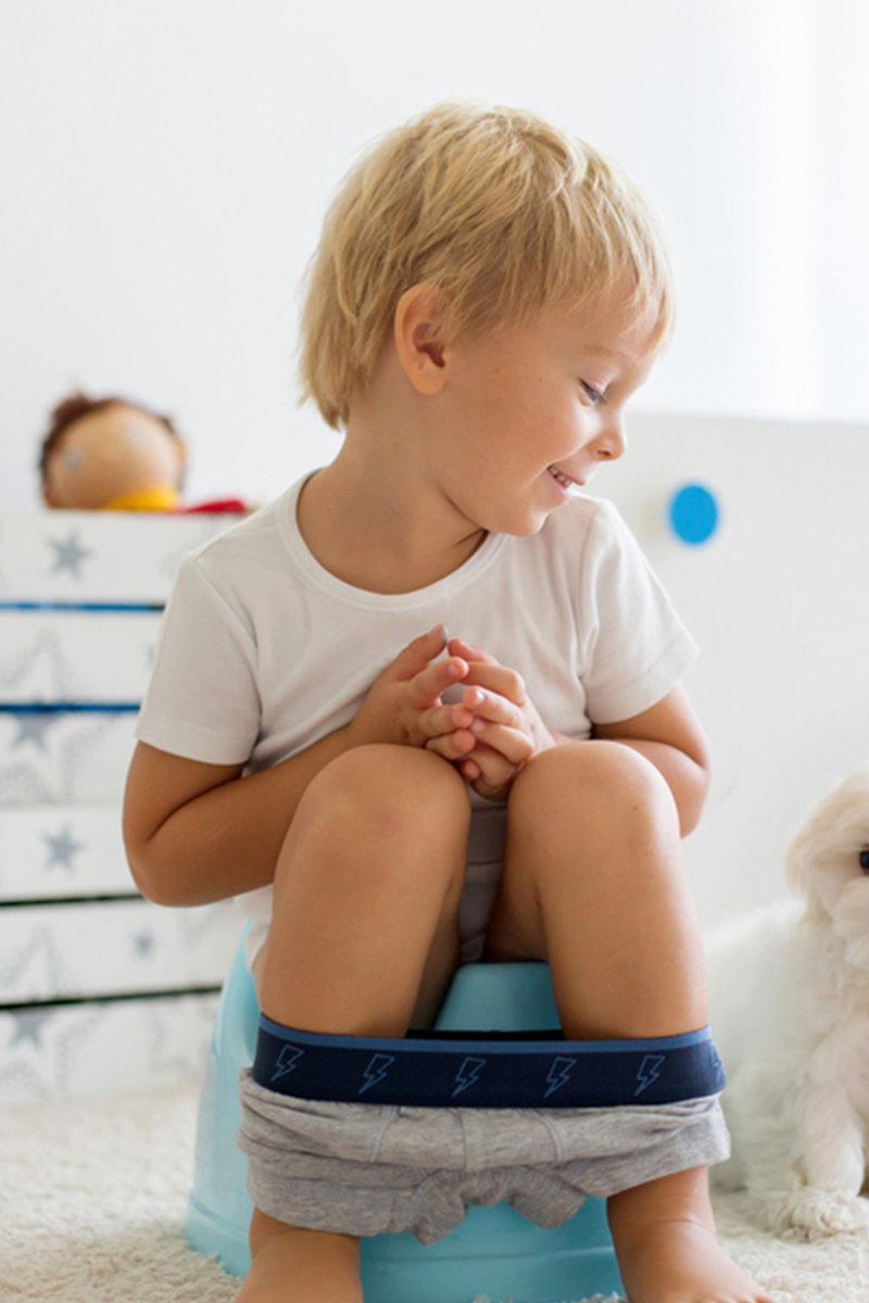 An illustration of a girl sitting on a potty