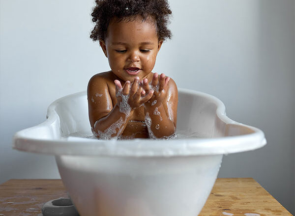baby sitting in a bubble bath