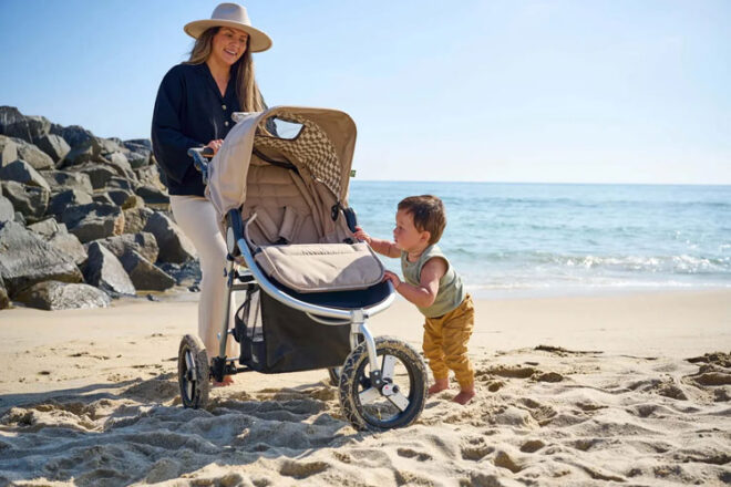 mother with bumbleride indie pram on the beach